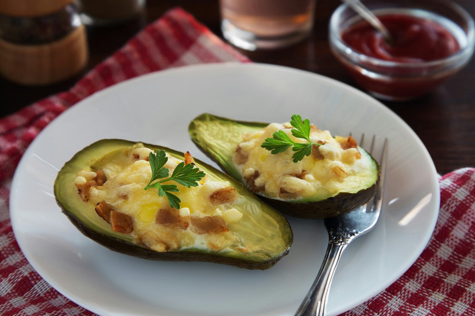 a white plate topped with two stuffed avocados